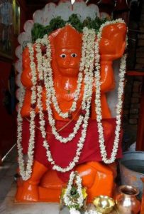 Shri Hanuman ji's idol are smeared by vermilion.