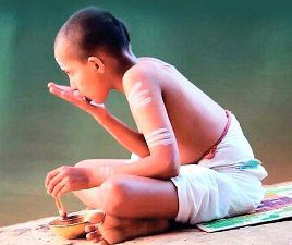 A child doing Aachaman